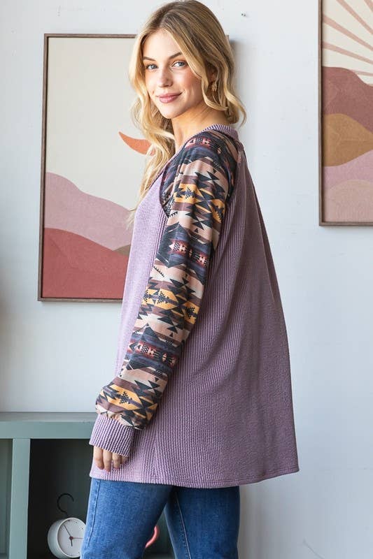 PURPLE RIBBED TOP WITH AZTEC SLEEVES.