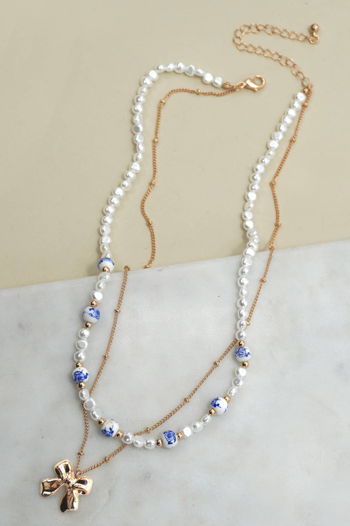 CERAMIC PORCELAIN PEARL BOW LAYER NECKLACE |
