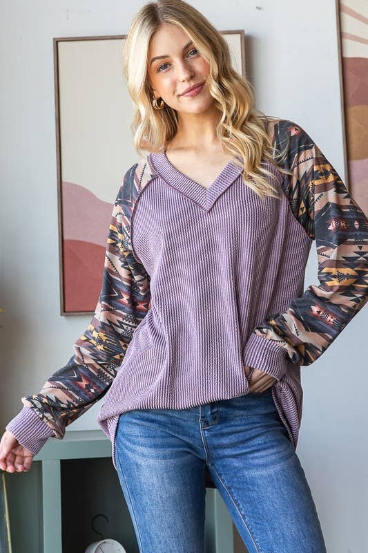 PURPLE RIBBED TOP WITH AZTEC SLEEVES.