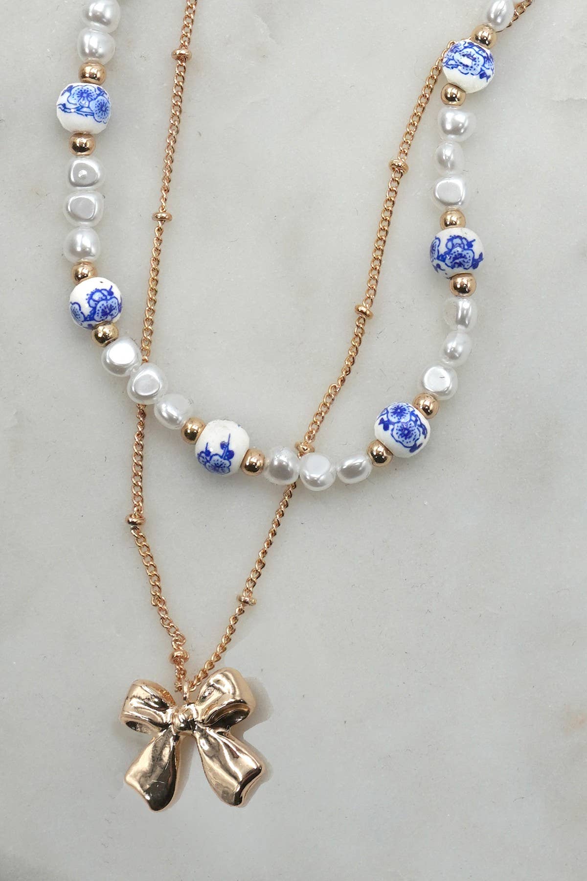 CERAMIC PORCELAIN PEARL BOW LAYER NECKLACE |